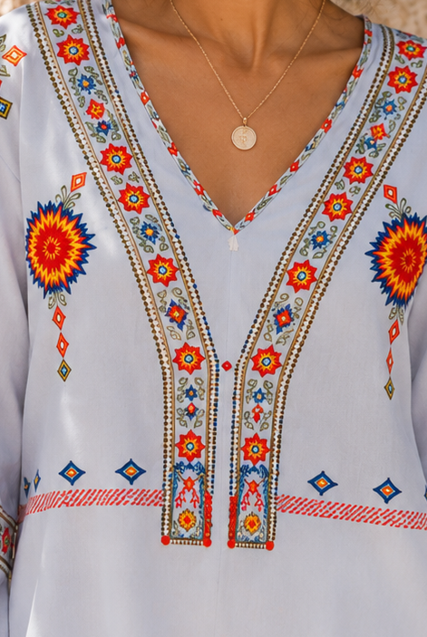 Bohemian embroidered summer blouse with V-neck by Lumina Wear, featuring colorful floral embroidery and relaxed fit.