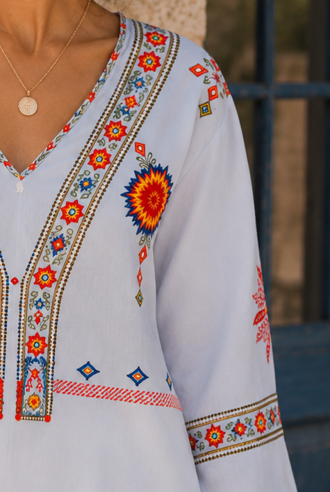 Bohemian embroidered summer blouse with V-neck from Lumina Wear, featuring colorful floral embroidery and lightweight fabric.