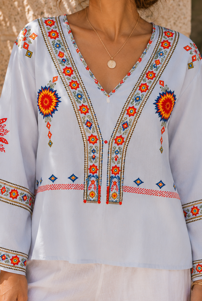 Bohemian embroidered summer blouse with V-neck from Lumina Wear, featuring colorful embroidery and lightweight fabric.