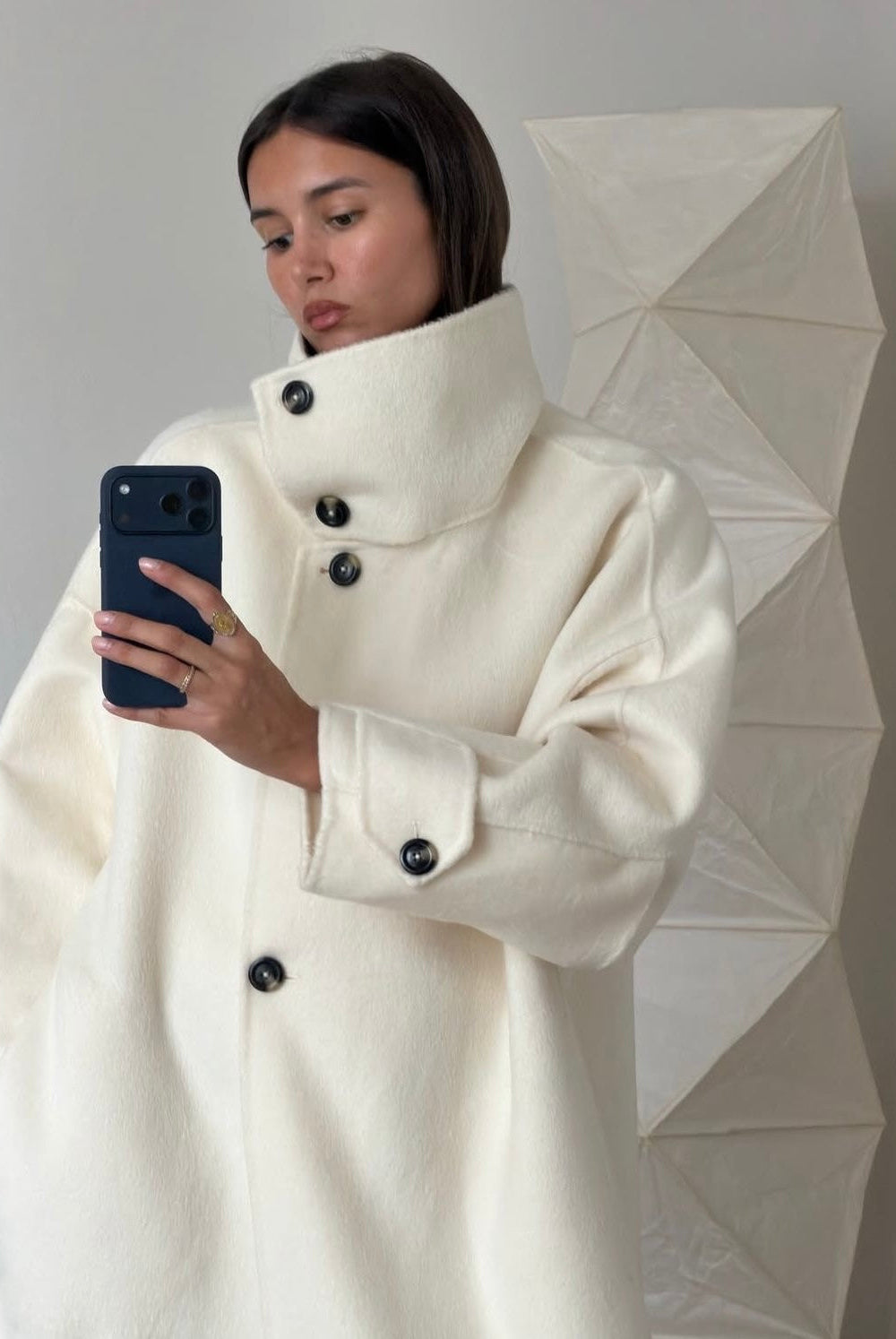Elegant Lumina Wear Amaya longline coat with structured design and high-neck style, displayed on a mannequin.