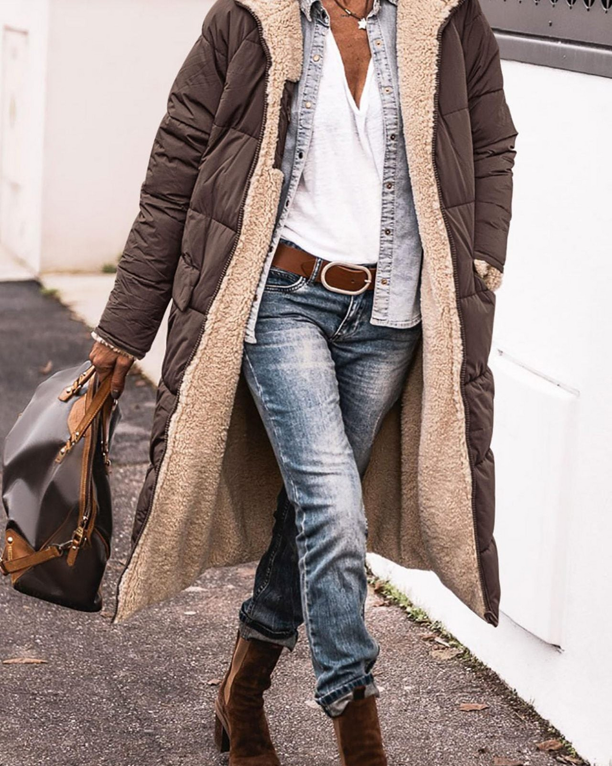 Lumina Wear Carina elegant reversible long winter coat for women with cozy warmth and stylish design, shown in a natural outdoor setting.