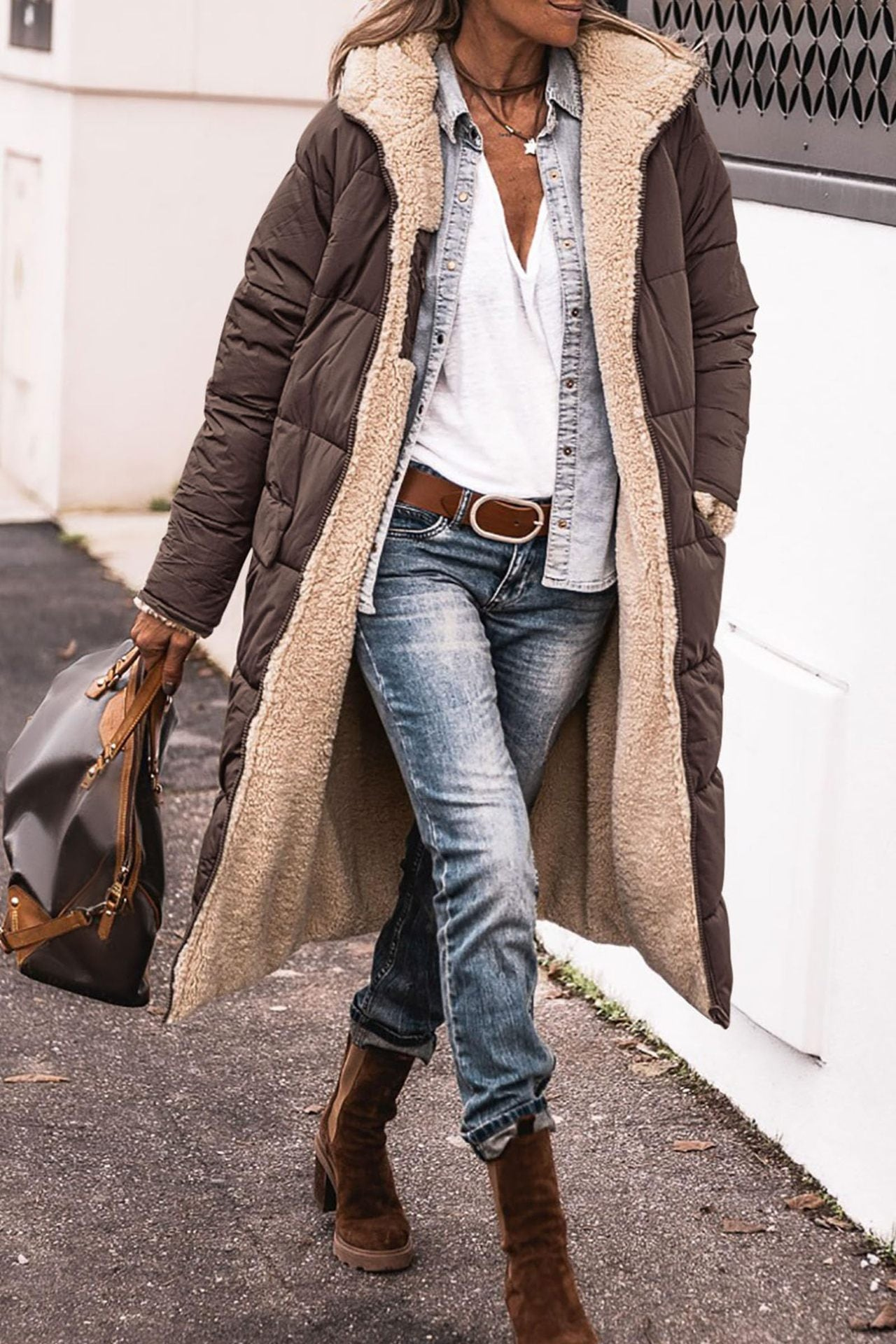 Lumina Wear Carina reversible long winter coat for women, showcasing cozy warmth and elegant design in a stylish outdoor setting.