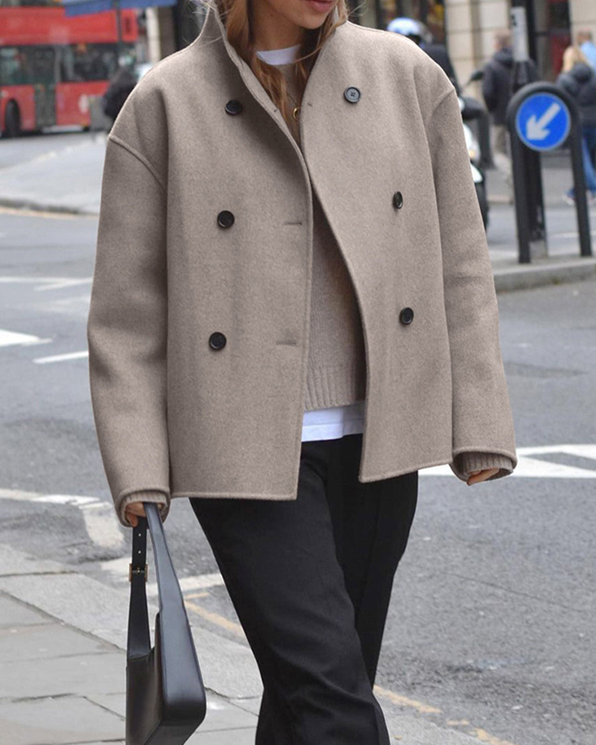 Black Charlene double-breasted peacoat with stand collar by Lumina Wear, shown on a model, highlighting its tailored fit and classic style.