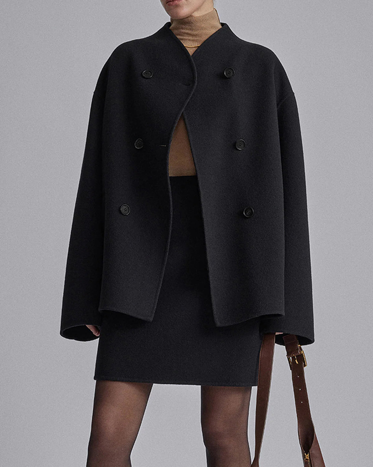 Black Charlene double-breasted peacoat with stand collar by Lumina Wear, shown on a model with front view and button details.