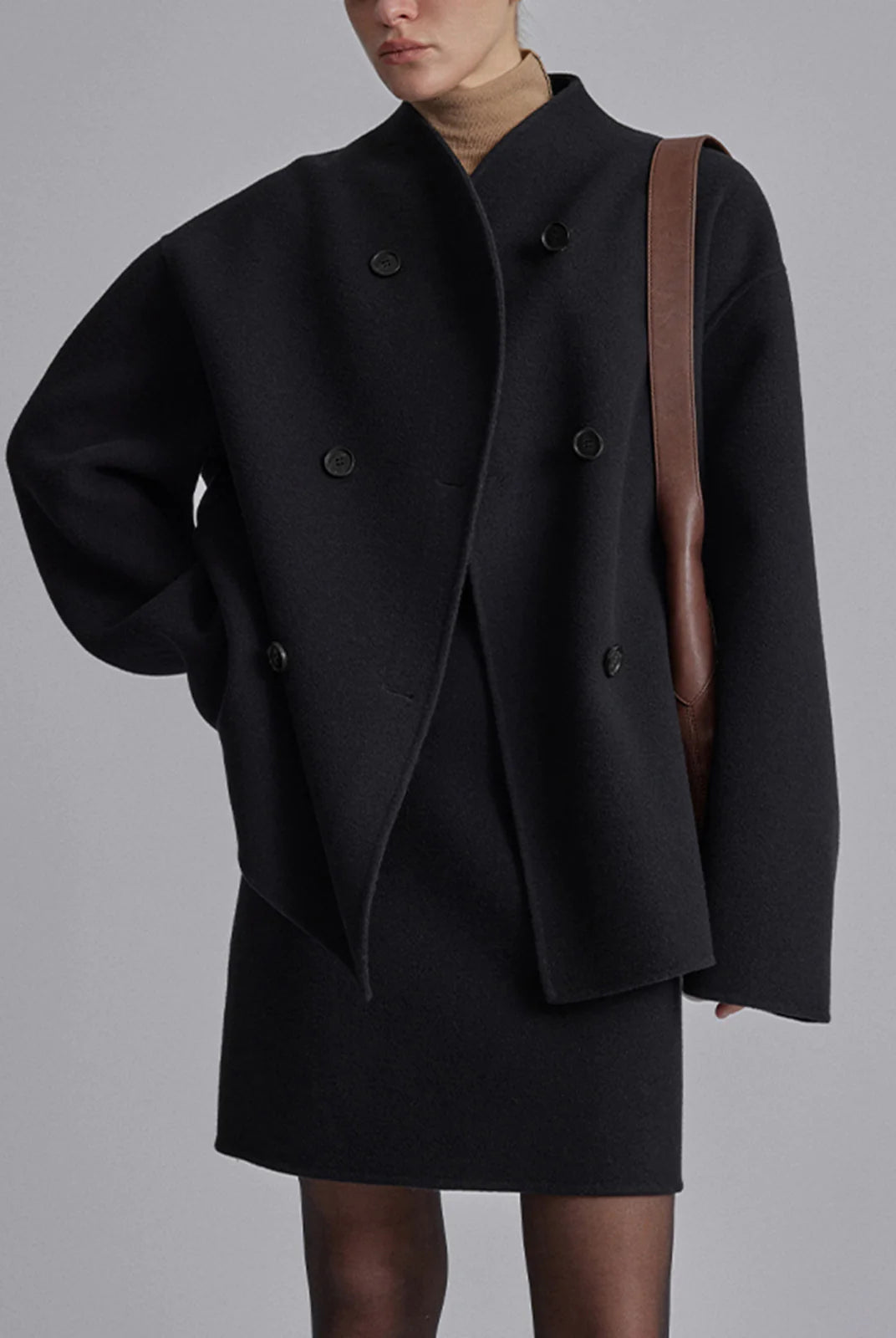 Black Charlene Lumina Wear double-breasted peacoat with stand collar, tailored for a classic, stylish winter look.