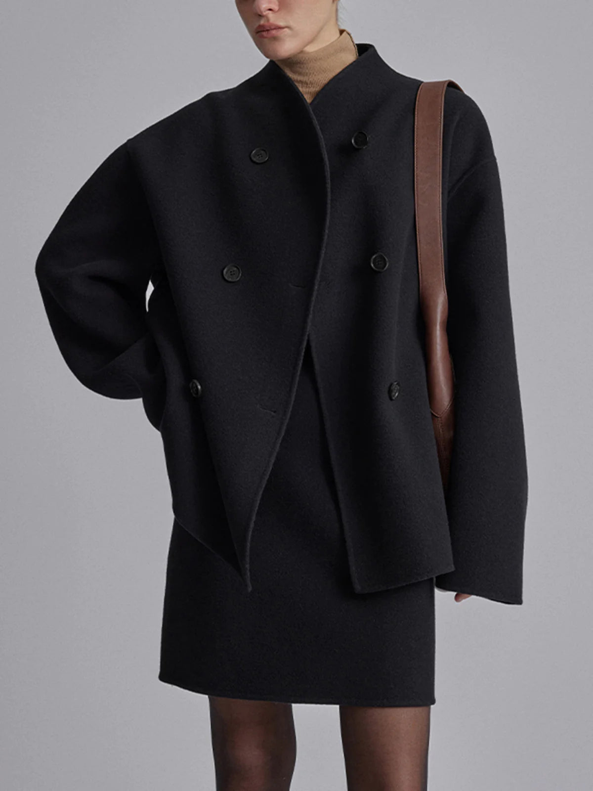 Black Charlene Lumina Wear double-breasted peacoat with stand collar, tailored for a classic, stylish winter look.