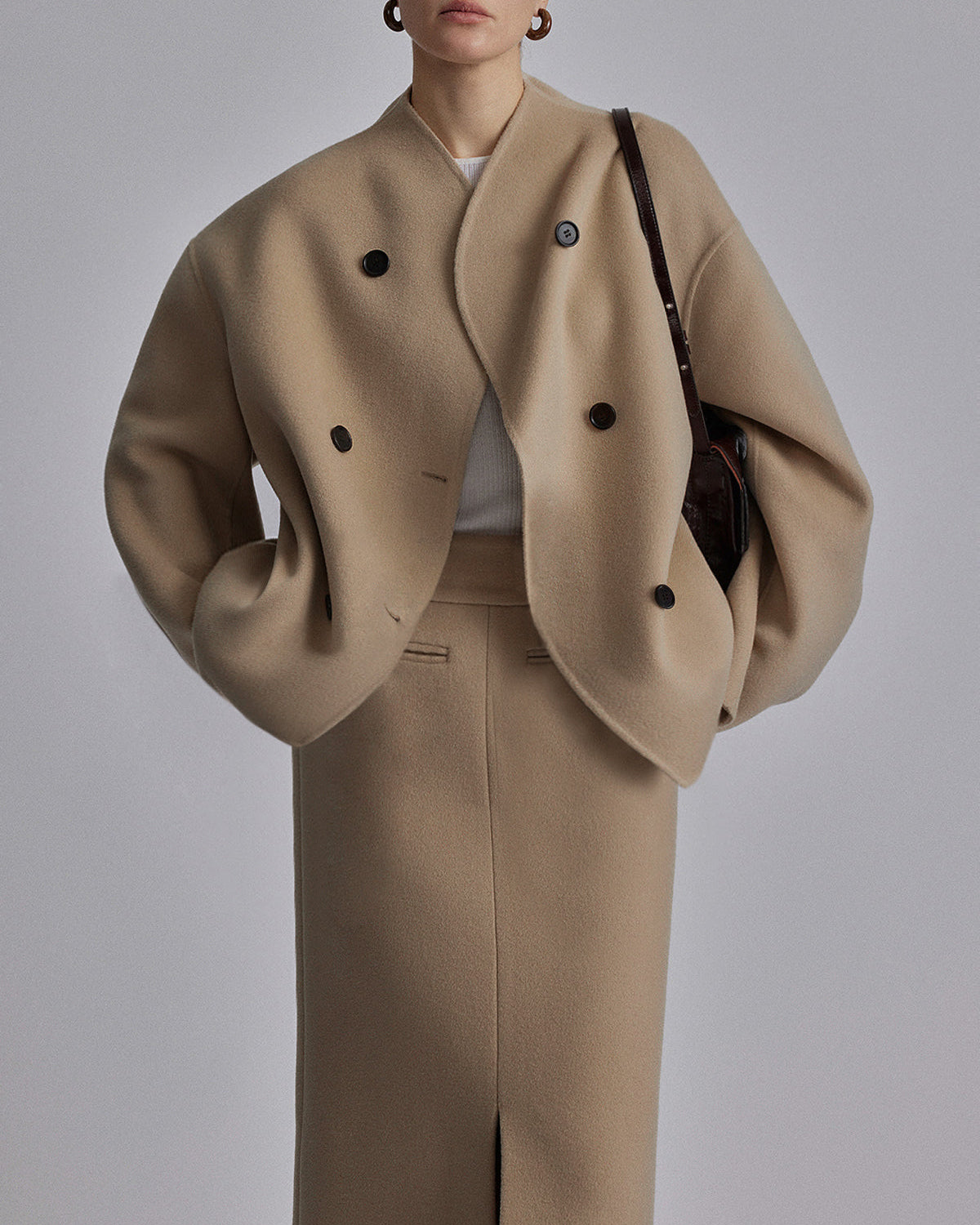 Black Charlene double-breasted peacoat with stand collar by Lumina Wear, showing front view and tailored fit.