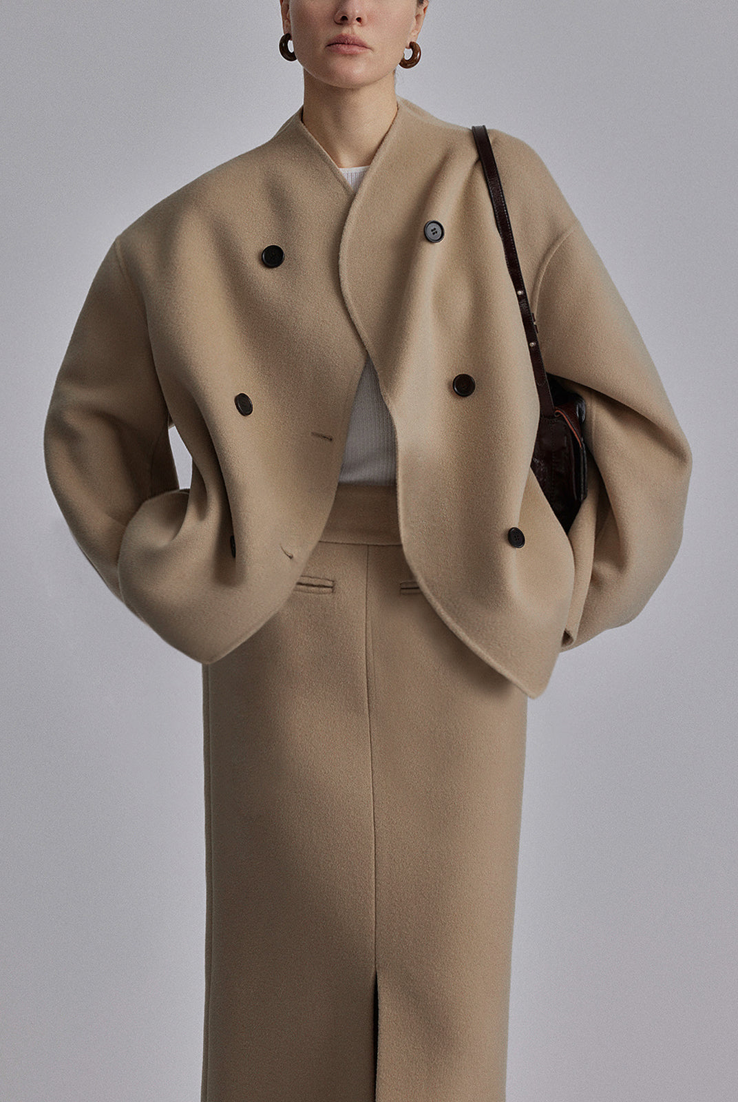 Black Charlene double-breasted peacoat with stand collar by Lumina Wear, shown on a model, showcasing its classic design and tailored fit.
