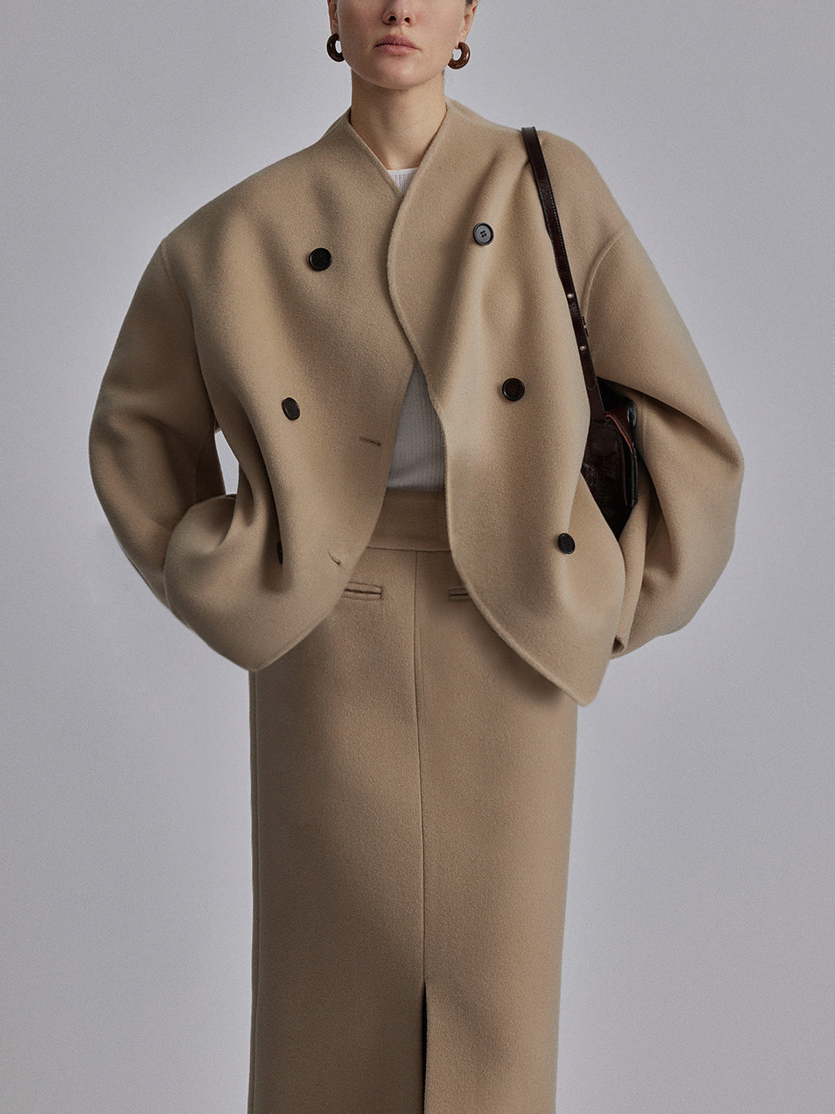 Black Charlene double-breasted peacoat with stand collar by Lumina Wear, shown on a model, showcasing its classic design and tailored fit.