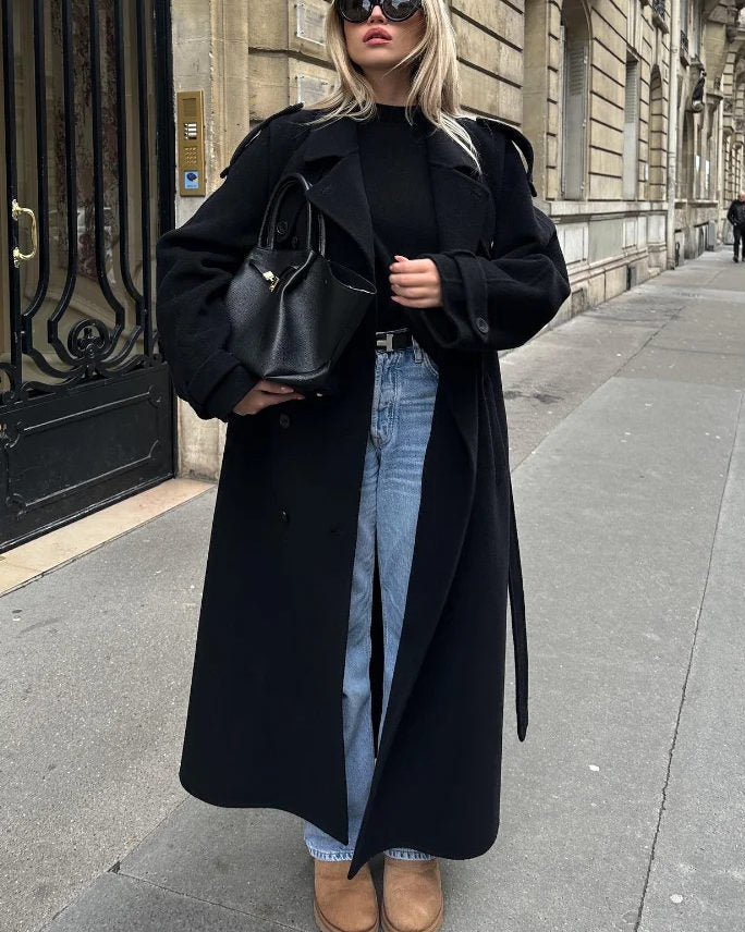 Black double-breasted trench coat with belted waist from Lumina Wear, featuring classic design and stylish silhouette.