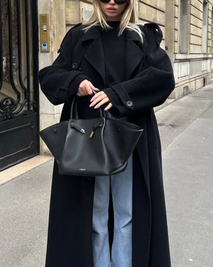 Black double-breasted trench coat with belted waist from Lumina Wear, featuring classic style and tailored fit.