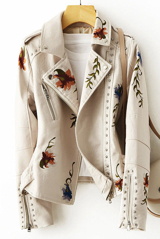 Women's leather jacket by Lumina Wear featuring floral embroidery, silver studs, and edgy design details.