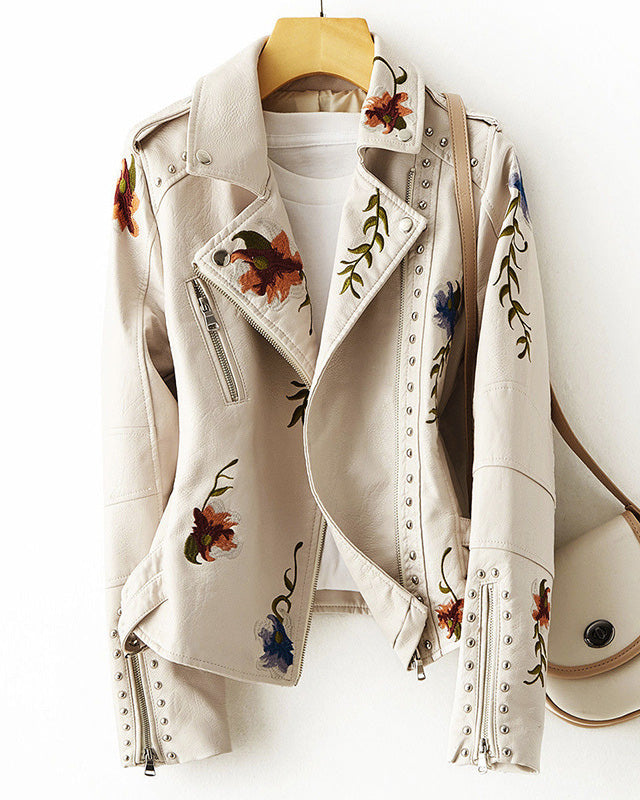 Leather jacket by Lumina Wear with floral embroidery, silver studs, edgy style, featuring detailed embroidery and metallic accents.