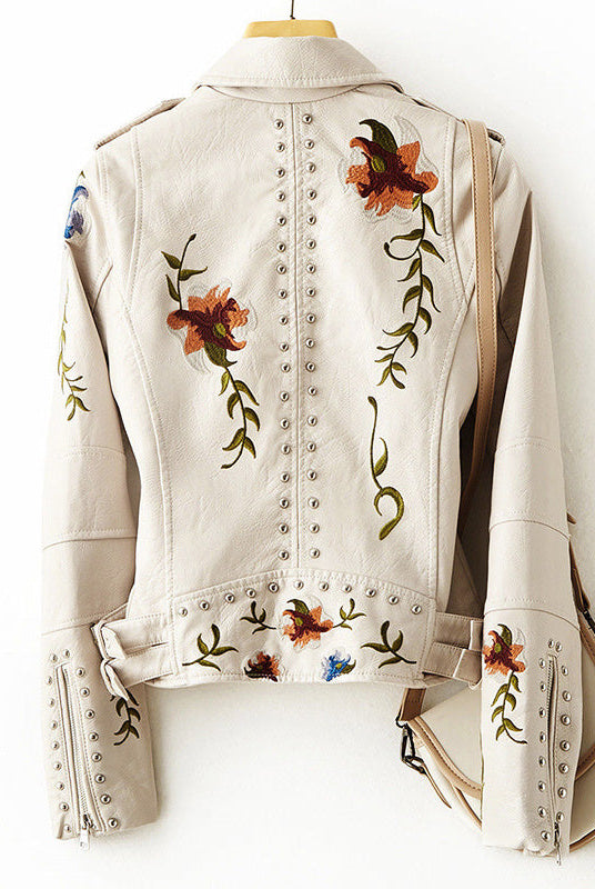 Women's leather jacket by Lumina Wear with edgy floral embroidery and silver studs, featuring a stylish and bold design.