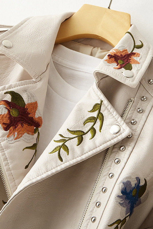 Women's leather jacket by Lumina Wear featuring floral embroidery, silver studs, and edgy design details.