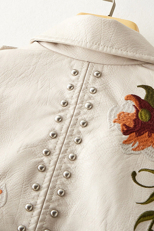 Women's leather jacket by Lumina Wear featuring floral embroidery, silver studs, and edgy design details.