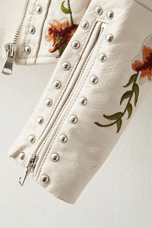 Women's leather jacket by Lumina Wear featuring floral embroidery, silver studs, and edgy style.