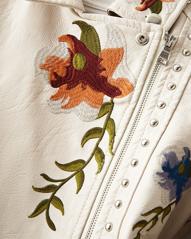 Leather jacket by Lumina Wear featuring floral embroidery, silver studs, and edgy style, showcased on a model.