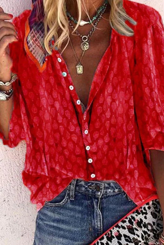 Brightly printed women's casual blouse with button front by Lumina Wear, featuring vibrant floral patterns and relaxed fit.