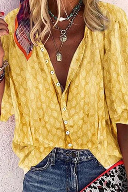 Vibrant printed women's casual blouse with button front from Lumina Wear, featuring colorful floral design and relaxed fit.
