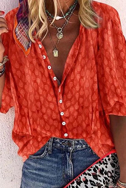 Brightly colored printed women's blouse with button front by Lumina Wear, featuring casual style and vibrant pattern.