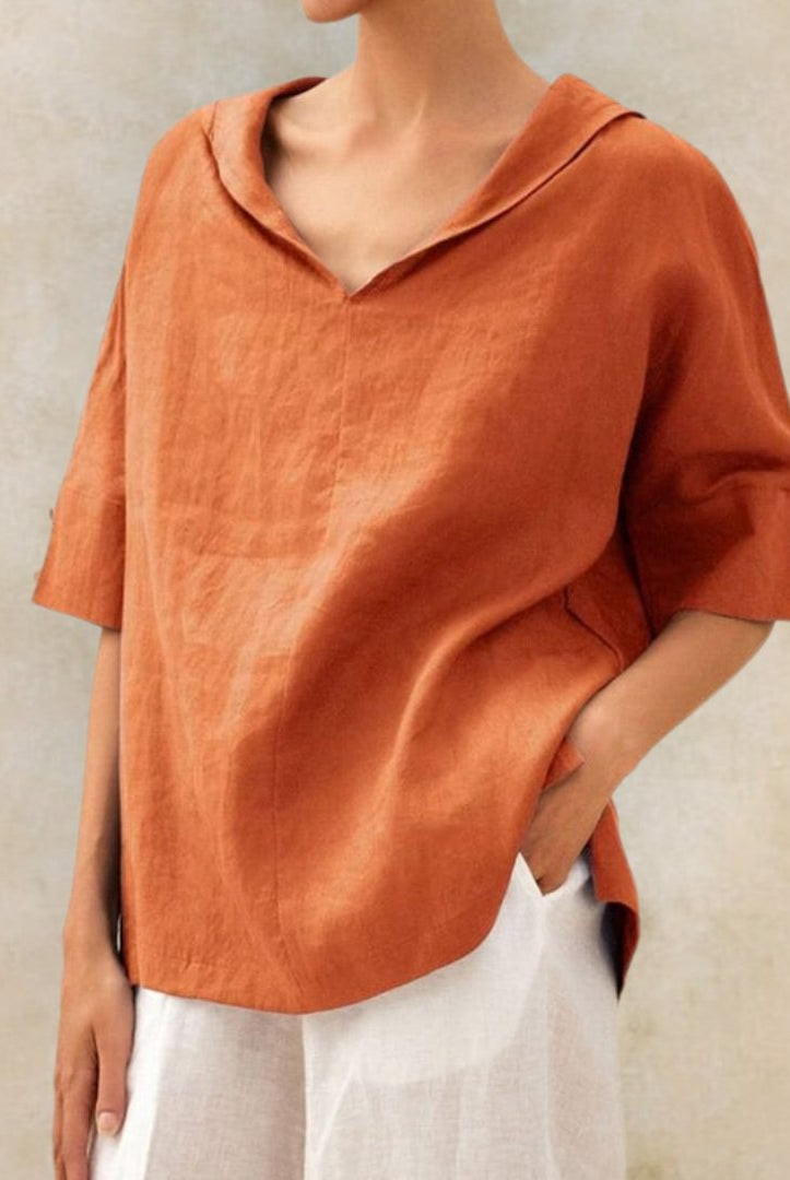 Light beige Lumina Wear Clara relaxed fit V-neck top with short sleeves, casual style, laid-back fit, on a flat lay background.