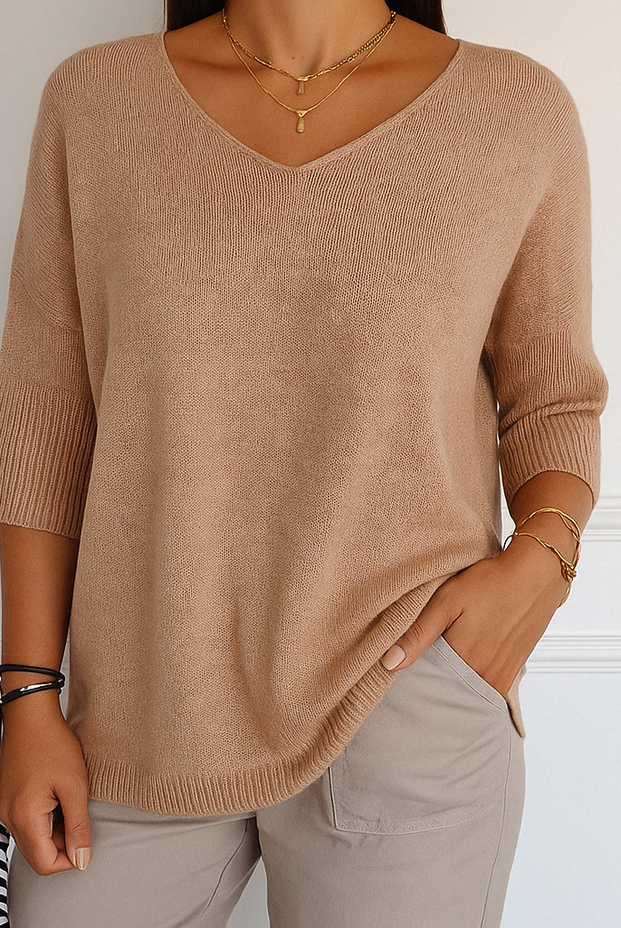 Cream-colored Lumina Wear Clara relaxed V-neck sweater with minimalist design, soft knit fabric, and comfortable fit.