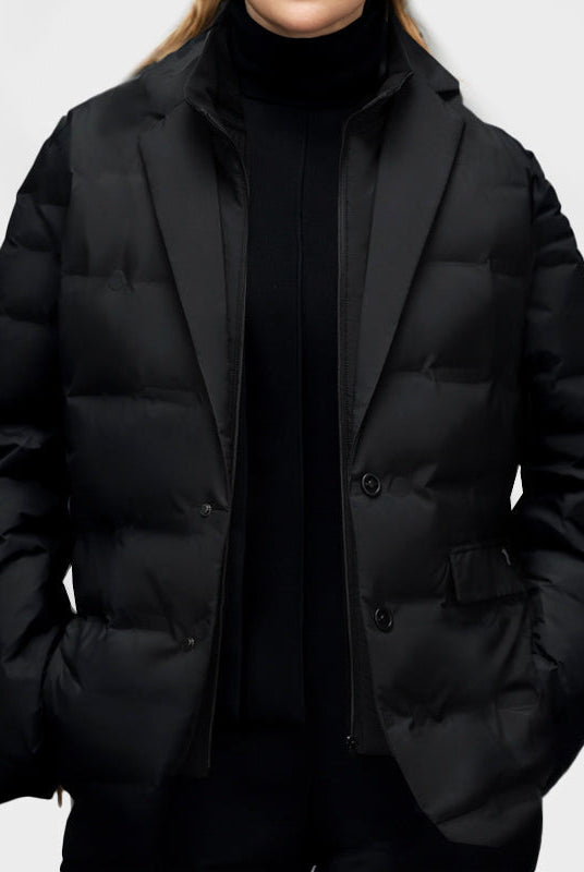Lumina Wear Elena women's lightweight water-resistant windbreaker with cozy insulation, shown in a stylish outdoor setting.