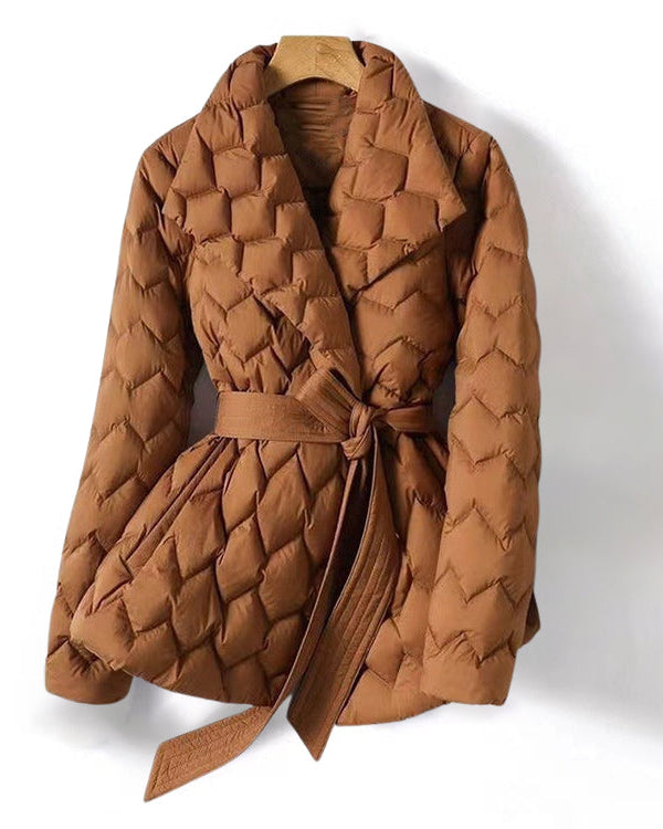 Lumina Wear Elise tailored geometric down puffer jacket with belted waist, featuring a sleek, structured design and quilted texture.