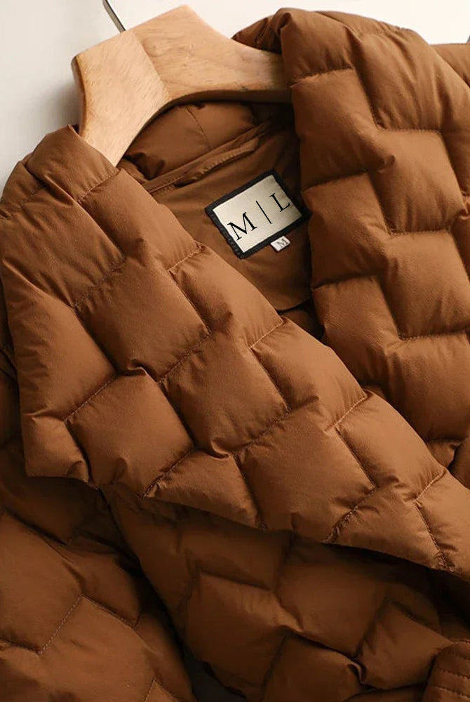 Lumina Wear Elise tailored geometric down puffer jacket with belted waist, featuring a sleek, quilted design and modern silhouette.