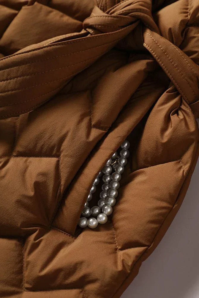 Lumina Wear Elise tailored geometric down puffer jacket with belted waist, featuring a stylish quilted design and warm insulation.