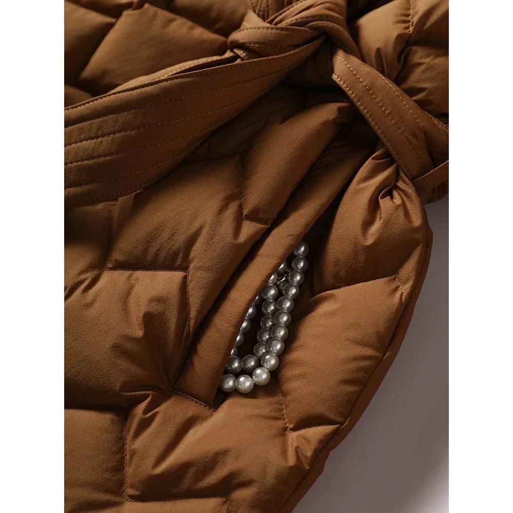 Lumina Wear Elise tailored geometric down puffer jacket with belted waist, featuring a stylish quilted design and warm insulation.