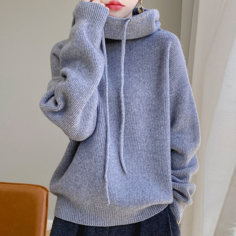 Lumina Wear Elise relaxed fit merino wool sweater with a tailored hood, showcasing soft texture and casual style.