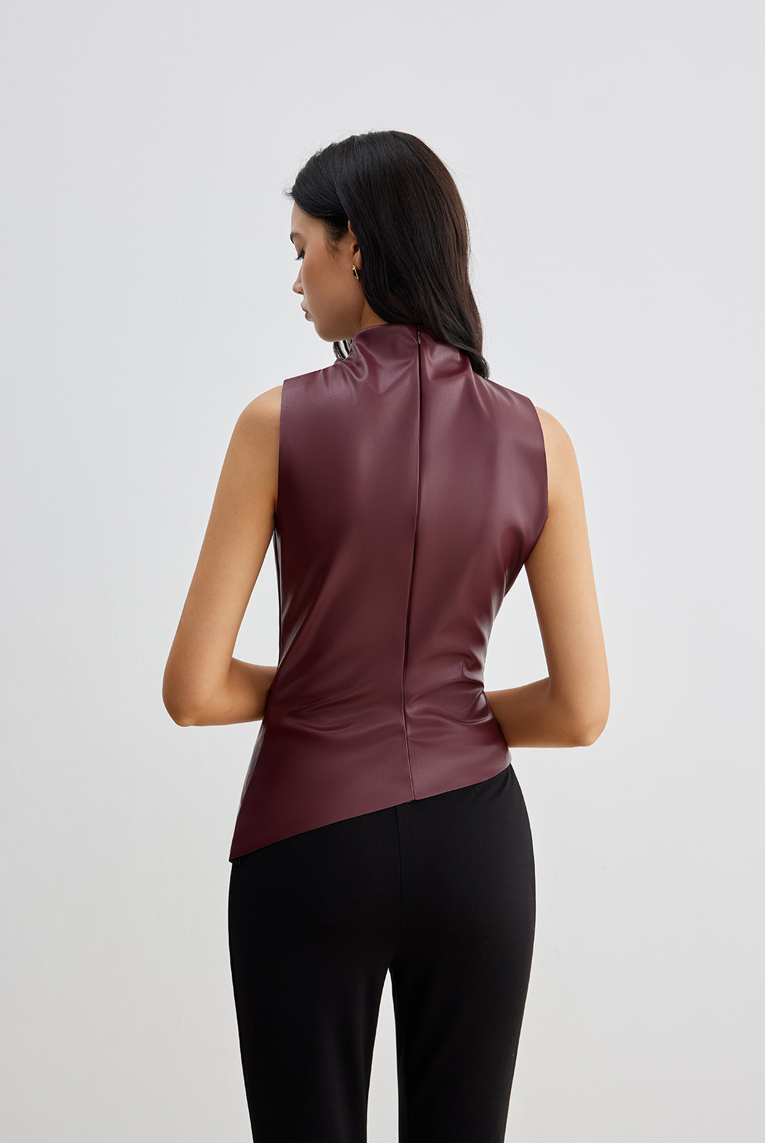Ella sleeveless high neck tank top for women by Lumina Wear, shown in a stylish black fabric, close-up of neckline and fit.
