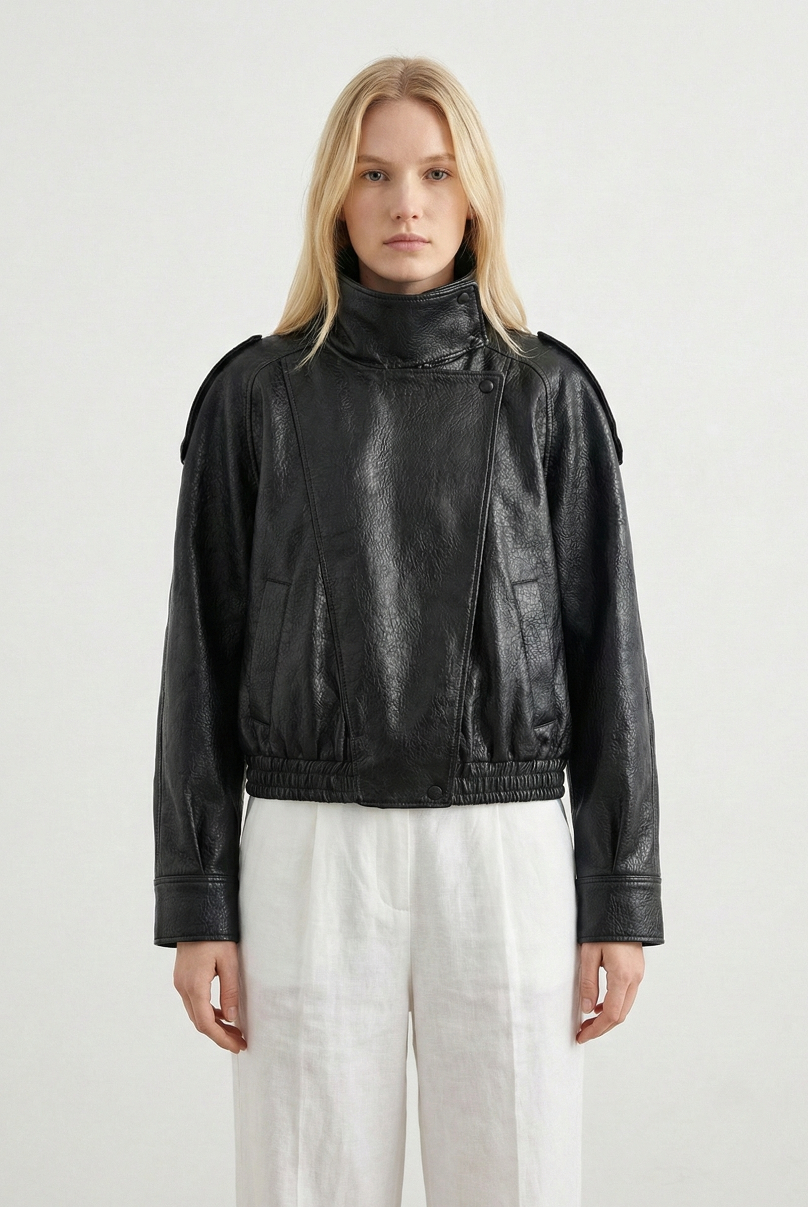 Women's oversized structured faux leather jacket with high neck, in black, featuring a sleek modern design by Lumina Wear.