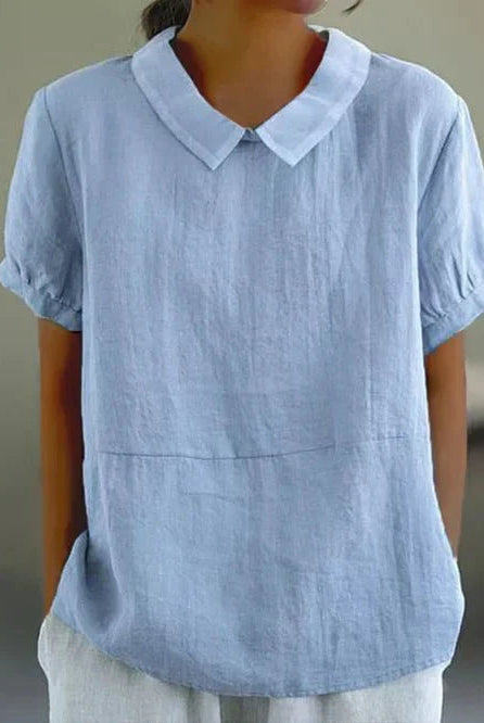 Linen blouse with Peter Pan collar from Lumina Wear, featuring a charming, feminine design and soft fabric in natural tones.