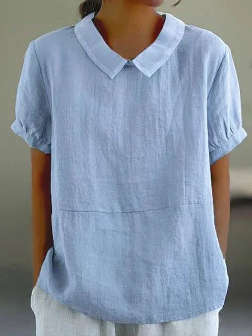 Linen blouse with Peter Pan collar from Lumina Wear, featuring a charming, feminine design and soft fabric in natural tones.