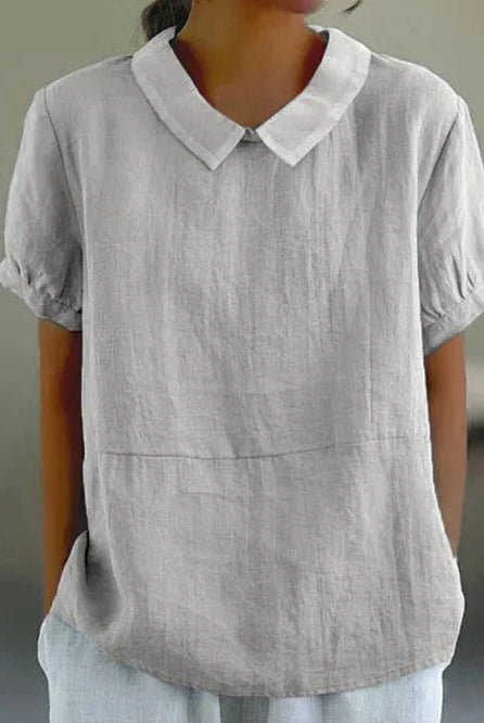 Light-colored linen blouse with a Peter Pan collar by Lumina Wear, featuring a charming and elegant design for women.