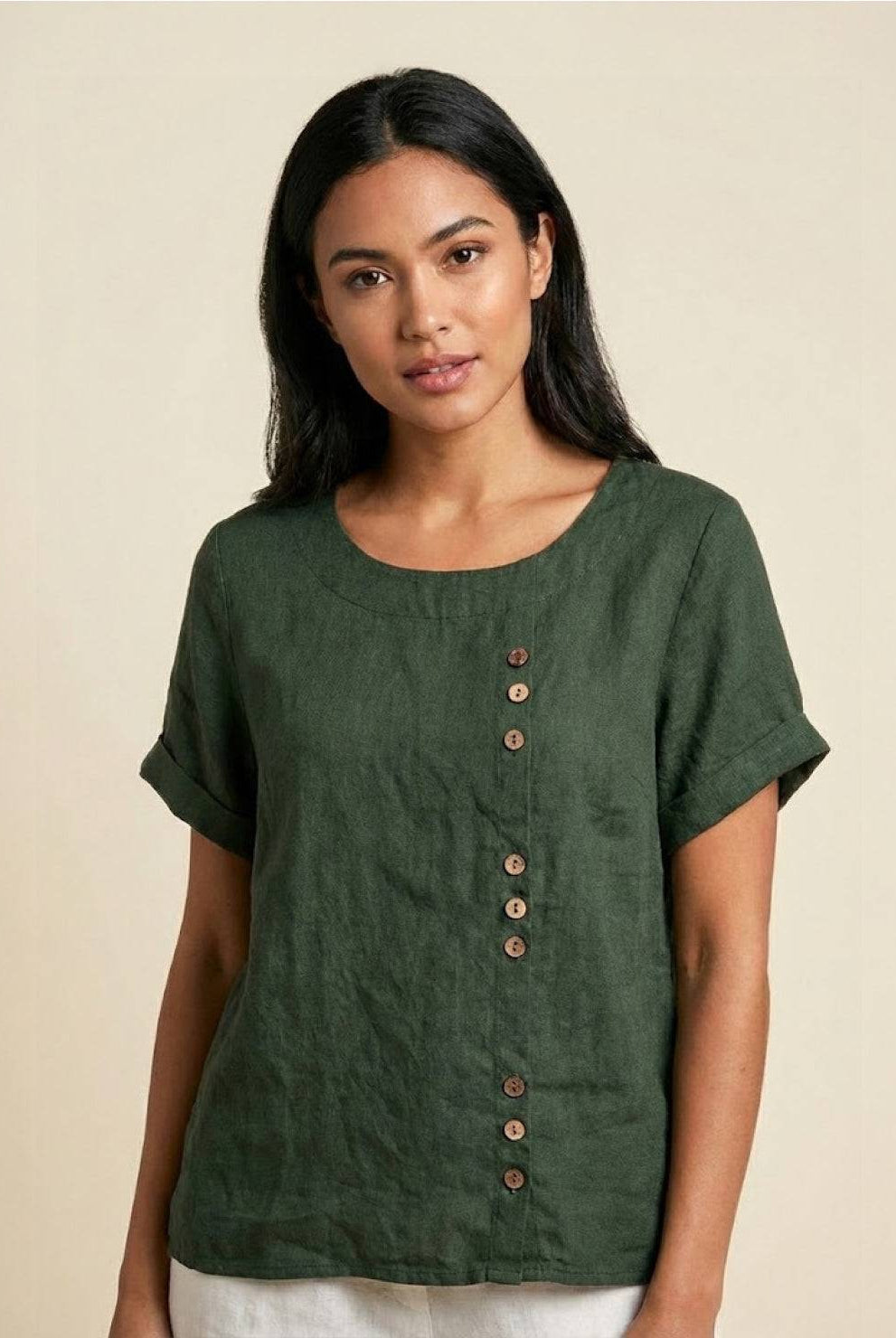 Light beige linen blouse with relaxed fit and button detail from Lumina Wear's Grace collection, displayed on a hanger.