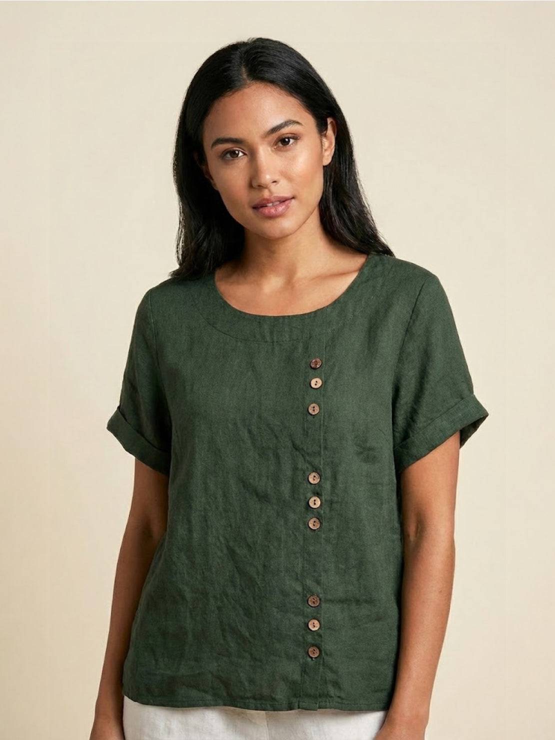 Light beige linen blouse with relaxed fit and button detail from Lumina Wear's Grace collection, displayed on a hanger.