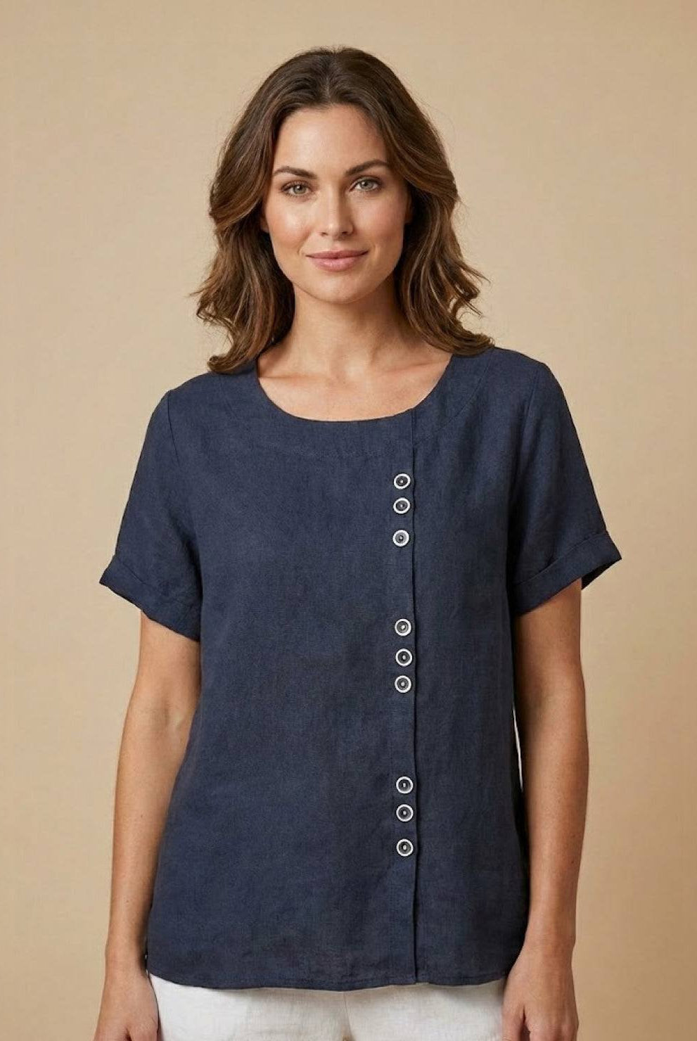 Linen blouse by Lumina Wear featuring relaxed fit, button details, and lightweight fabric in a neutral tone.