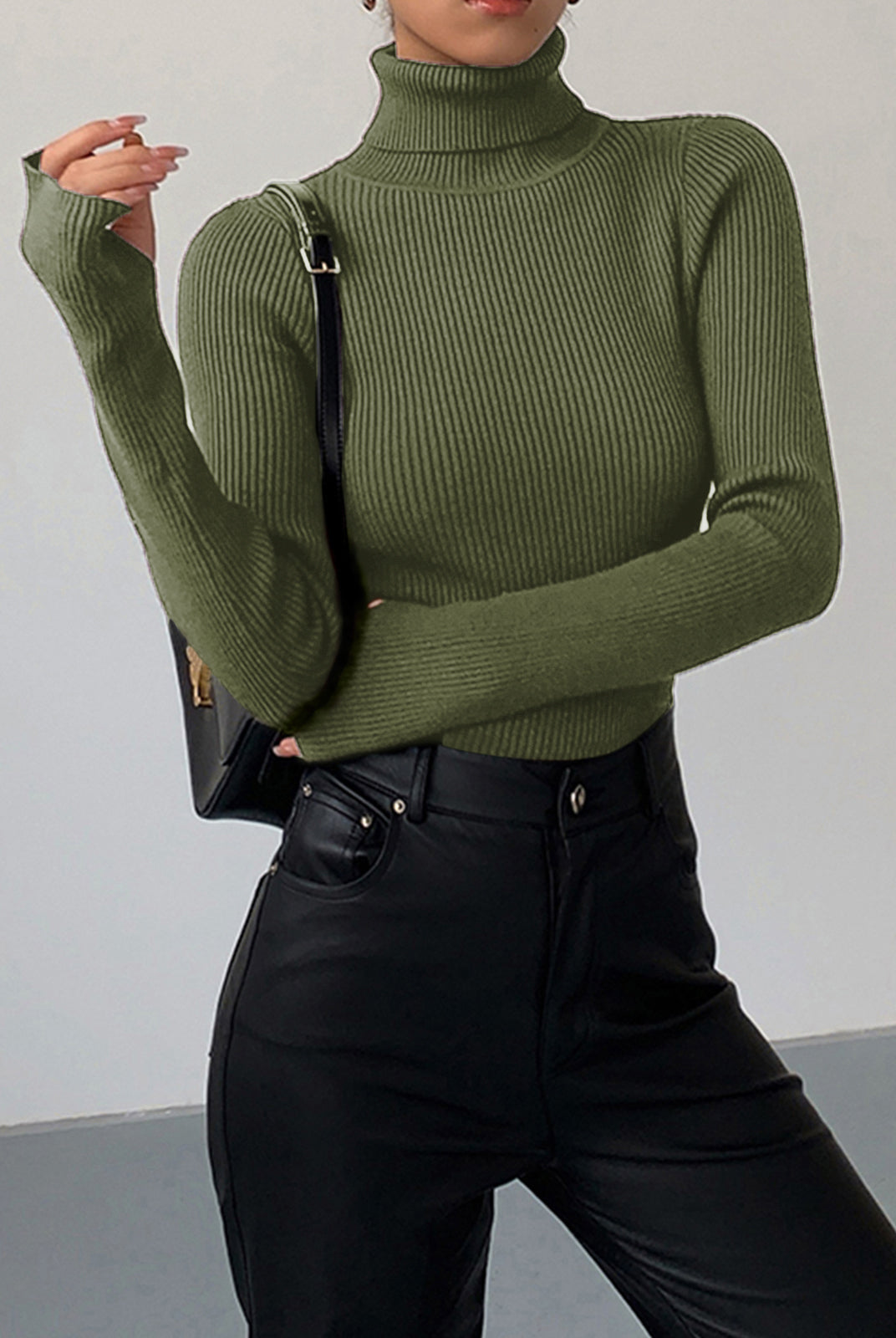 Lumina Wear Hailey minimalist black turtleneck top, sleek winter fashion, close-up of the fitted collar and smooth fabric.