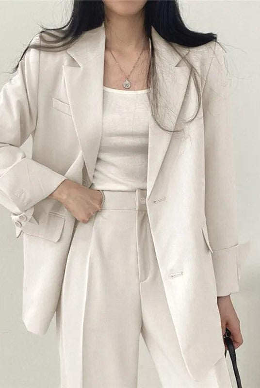 Lumina Wear Hailey tailored blazer and high-waisted trousers suit set, stylish formal outfit for women, in a professional setting.