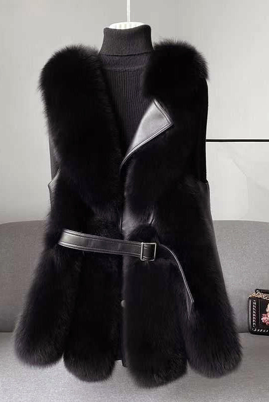 Isabella Lumina faux fur vest with leather trim, belted waist, and sleek silhouette, featuring a stylish and cozy design.