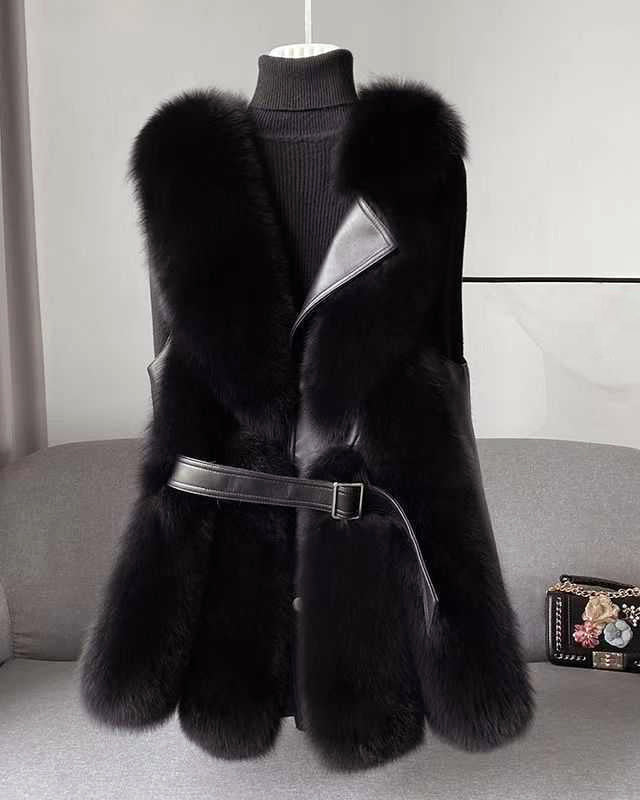 Lumina Wear Isabella belted faux fur vest with leather trim, showcasing a sleek silhouette and stylish details in a close-up image.