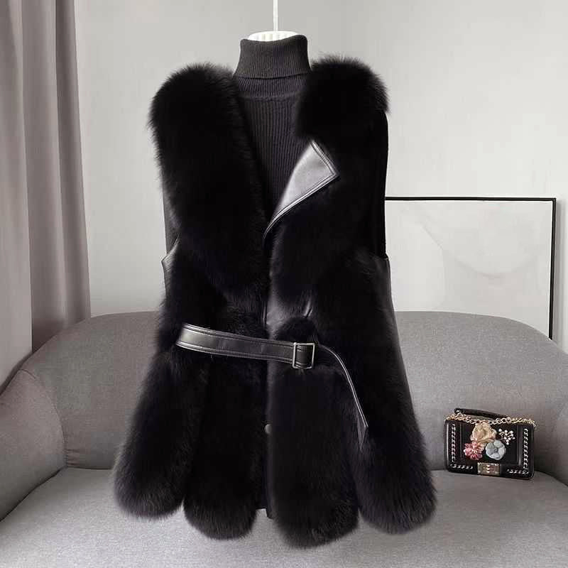 Isabella Lumina faux fur vest with leather trim, belted waist, and sleek silhouette, featuring a stylish and cozy design.