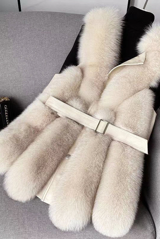 Isabella Lumina faux fur vest with leather trim, belted waist, and sleek silhouette, showcasing luxurious texture and stylish design.