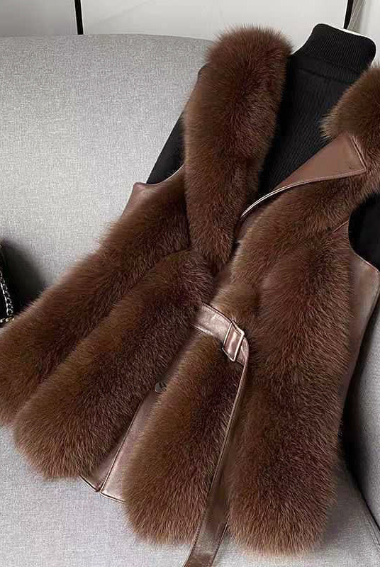 Luxurious Isabella faux fur vest with leather trim and sleek silhouette from Lumina Wear, featuring belt details and cozy texture.
