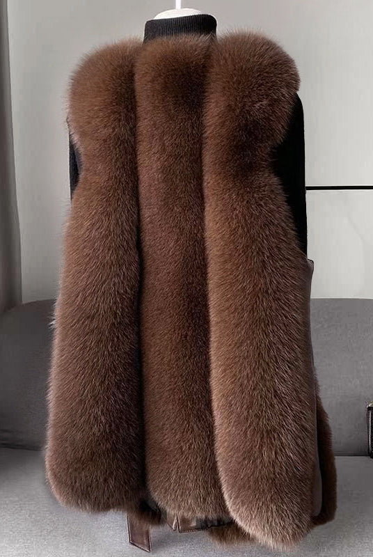 Isabella Lumina faux fur vest with leather trim, belt detail, and sleek silhouette, styled with a modern, sophisticated look.