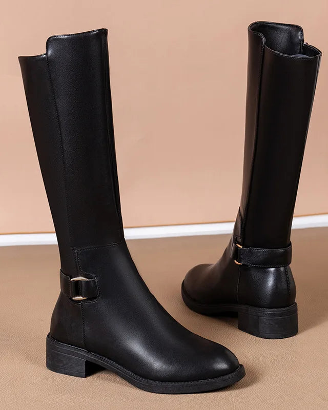Black knee-high boots with buckle accents from Lumina Wear's Isabella collection, featuring a sleek design and pointed toe.